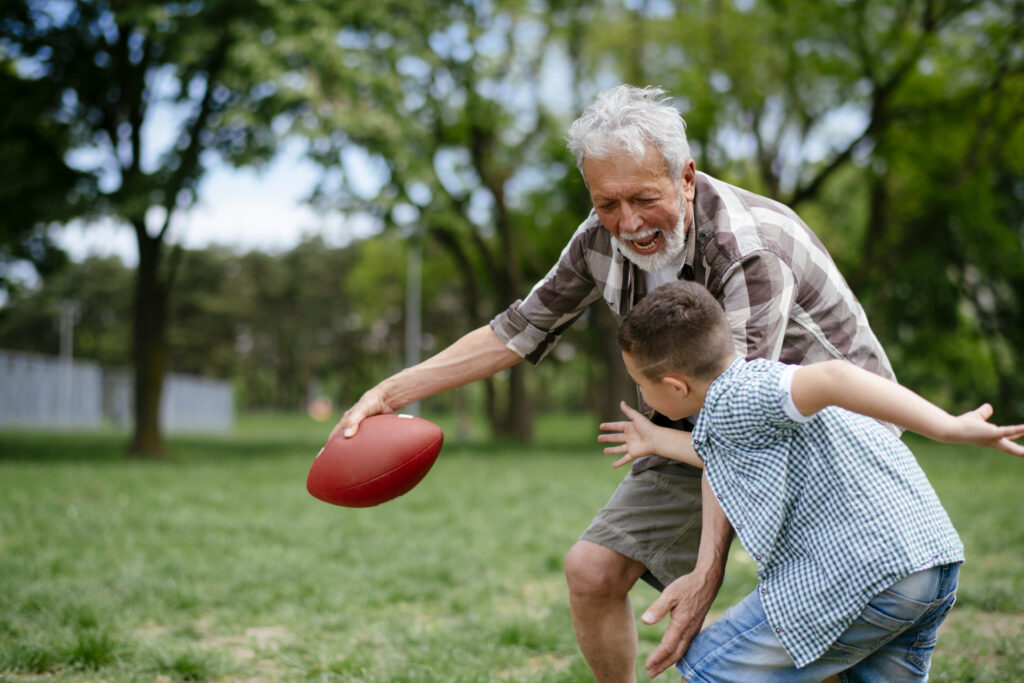 Grandson And Grandfather Playing Rugby